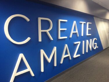 Interior wall at Burns & McDonnell with large dimensional letters saying, "CREATE AMAZING"