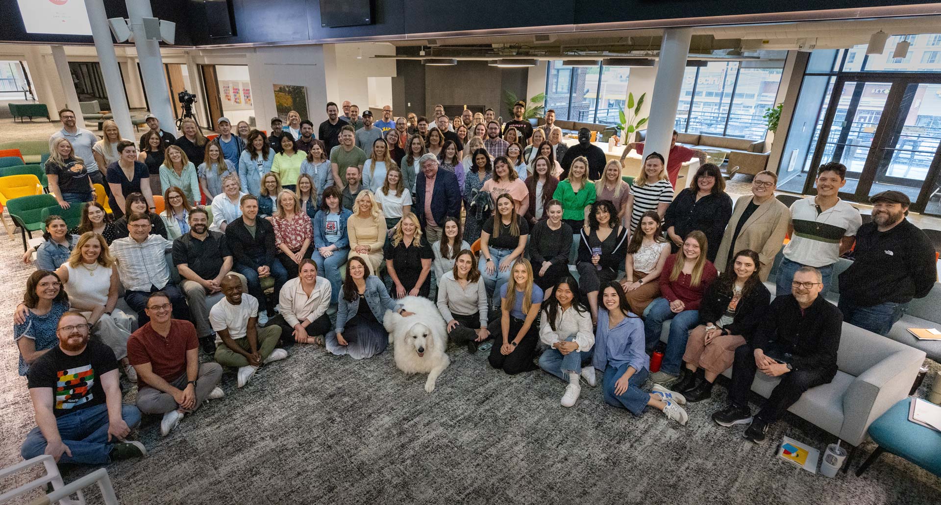 A large group portrait of the full Signal Theory staff all arranged in a tiered semi-circle in the Kansas City office atrium.