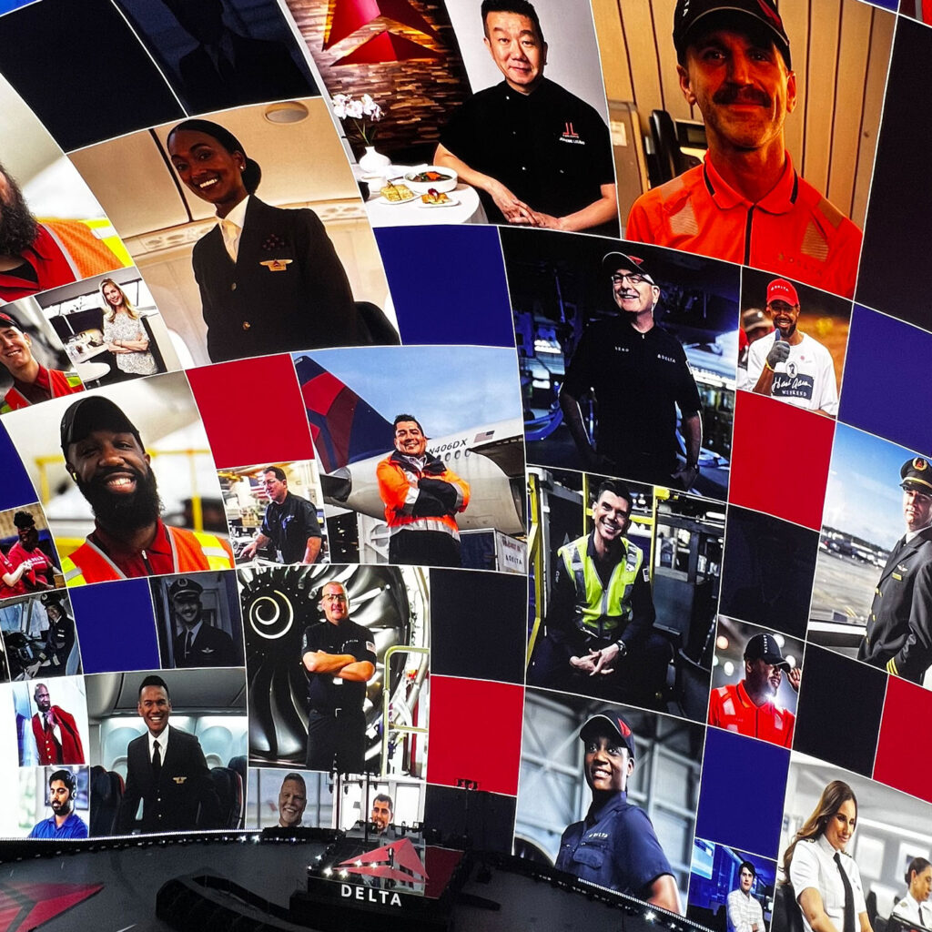 a view of the inside of the Vegas Sphere, showing images of various people working at Delta on the curved screen