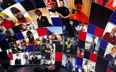 a view of the inside of the Vegas Sphere, showing images of various people working at Delta on the curved screen