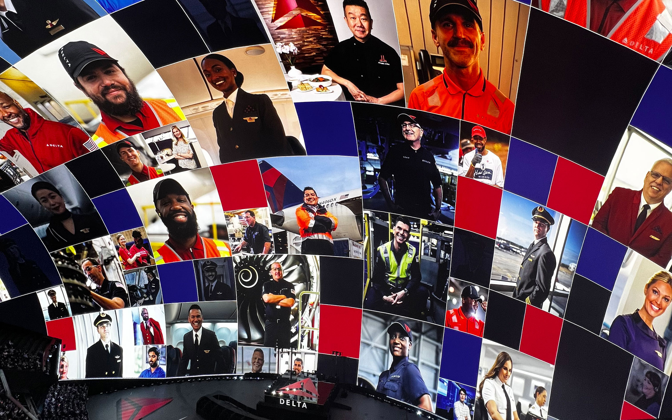 a view of the inside of the Vegas Sphere, showing images of various people working at Delta on the curved screen