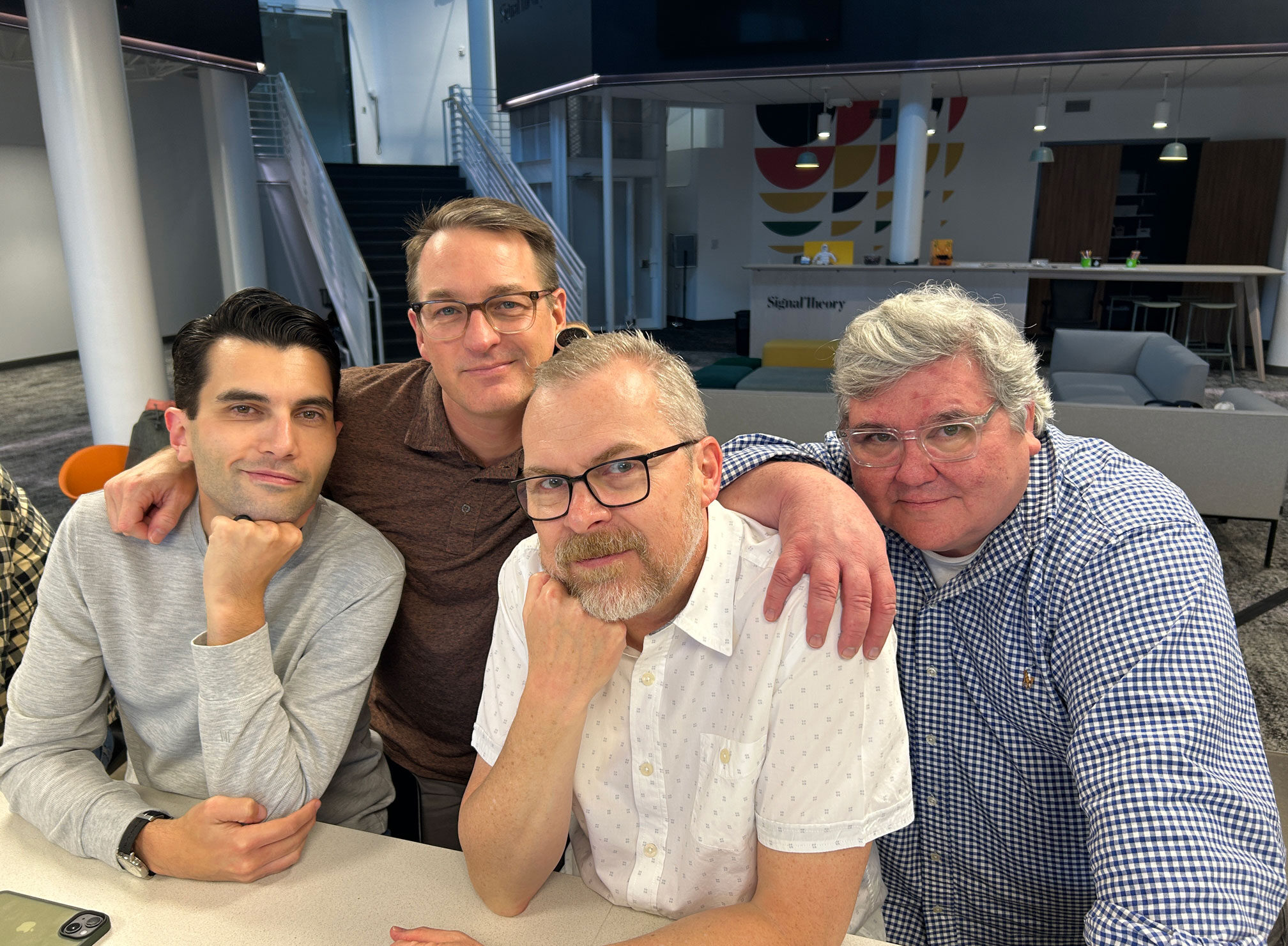 Jon Kowing with friends at his in-office retirement party posing seriously for the camera